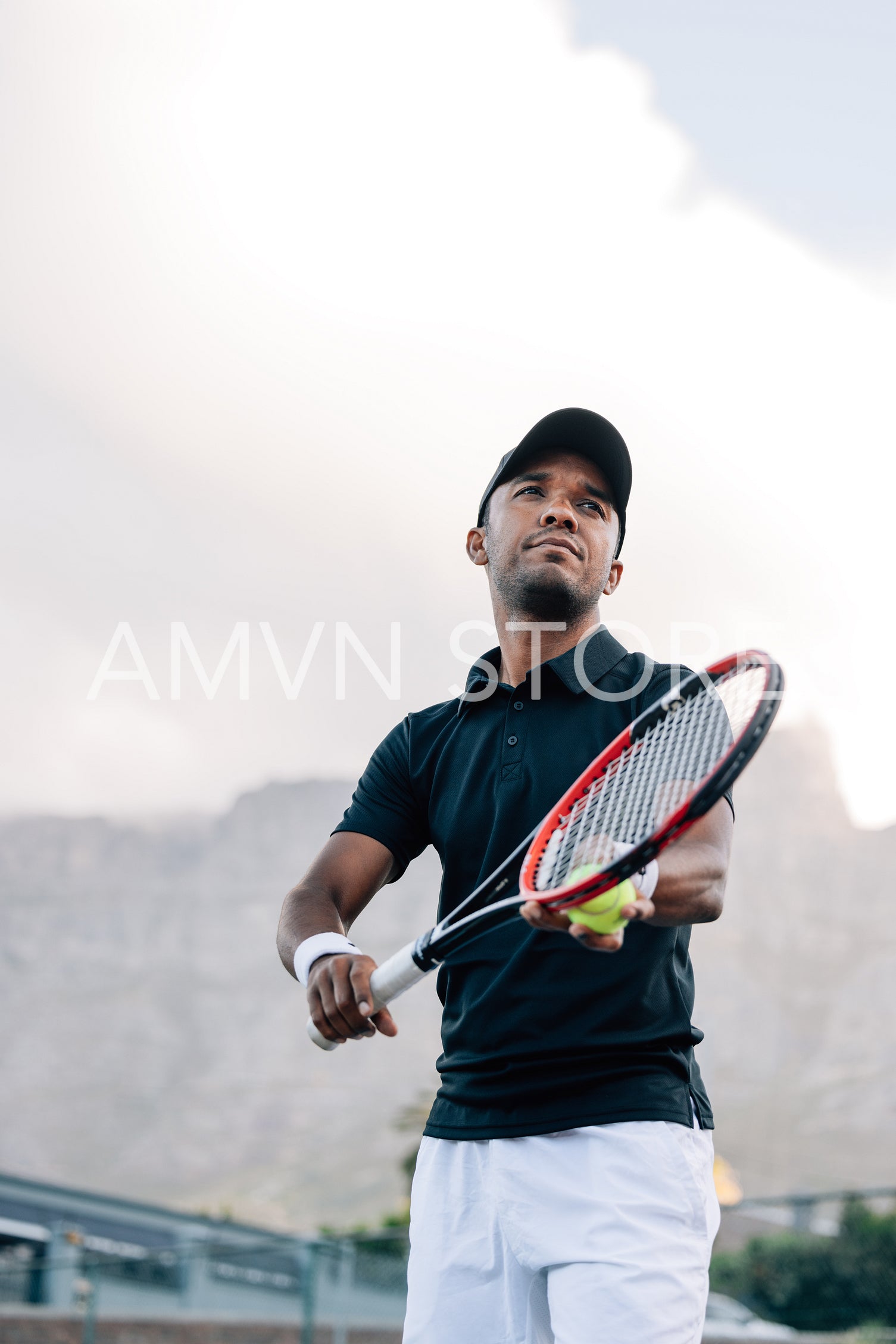 Tennis player preparing to serve the ball in a match