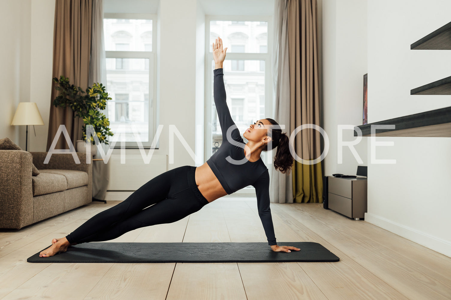 Woman in sports clothing doing workout at home on mat	