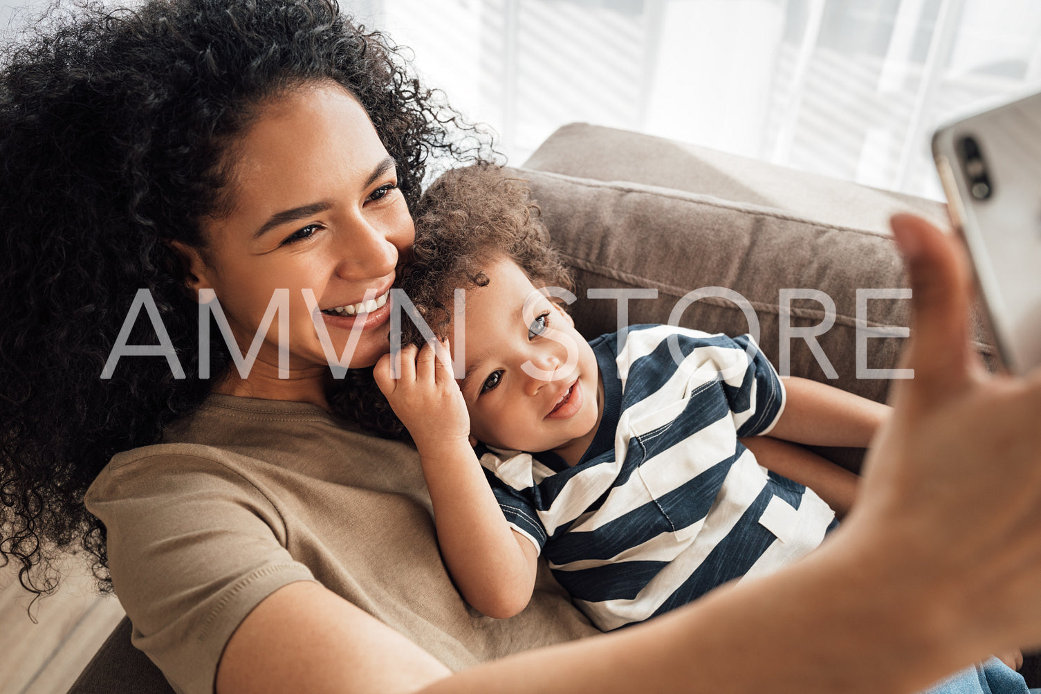 Smiling mother with her baby boy taking a selfie