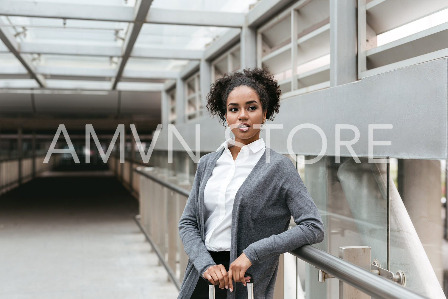 Confident woman standing in corridor at station	