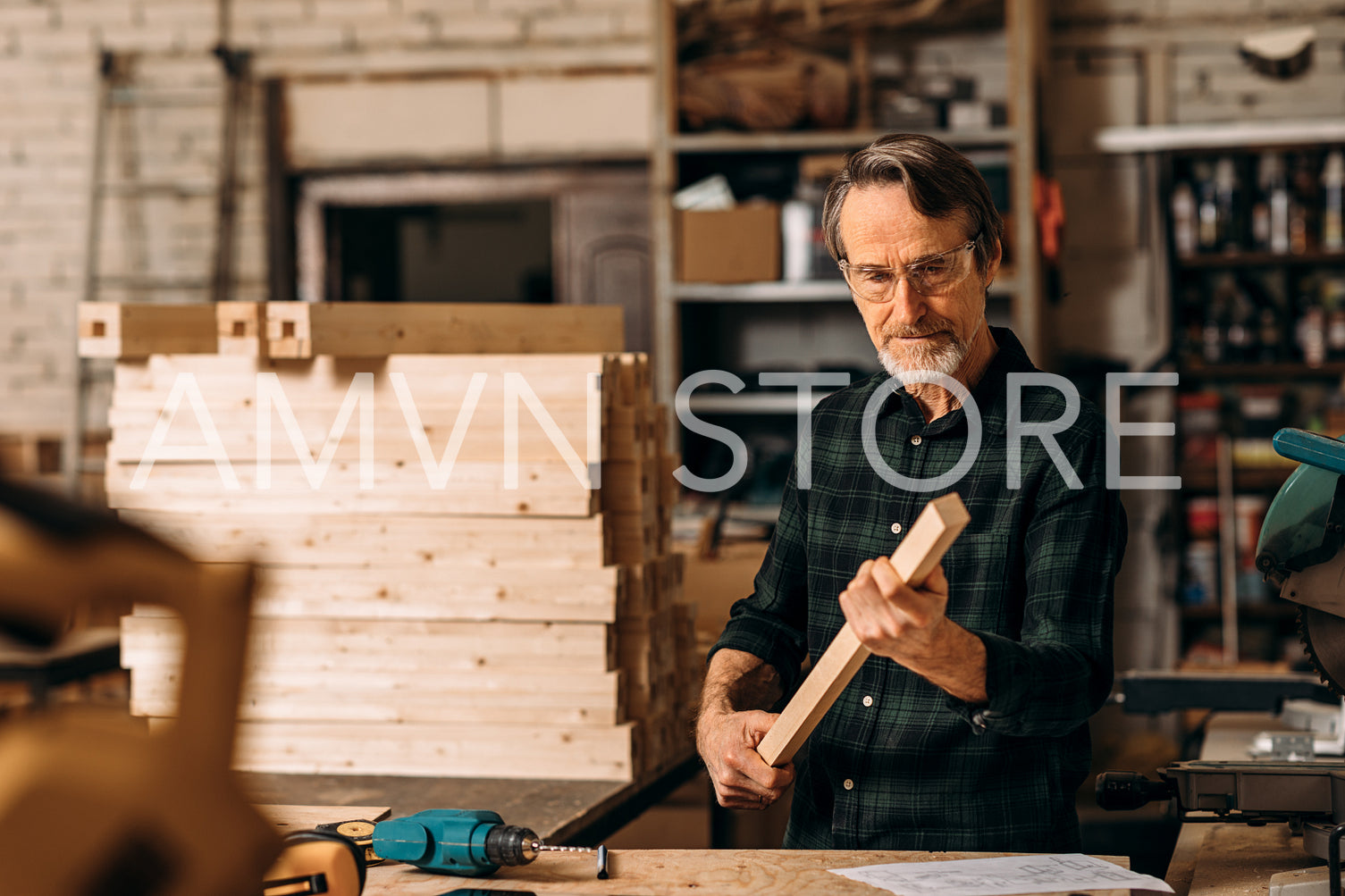 Carpenter checking wood part for straightness while preparing for furniture	