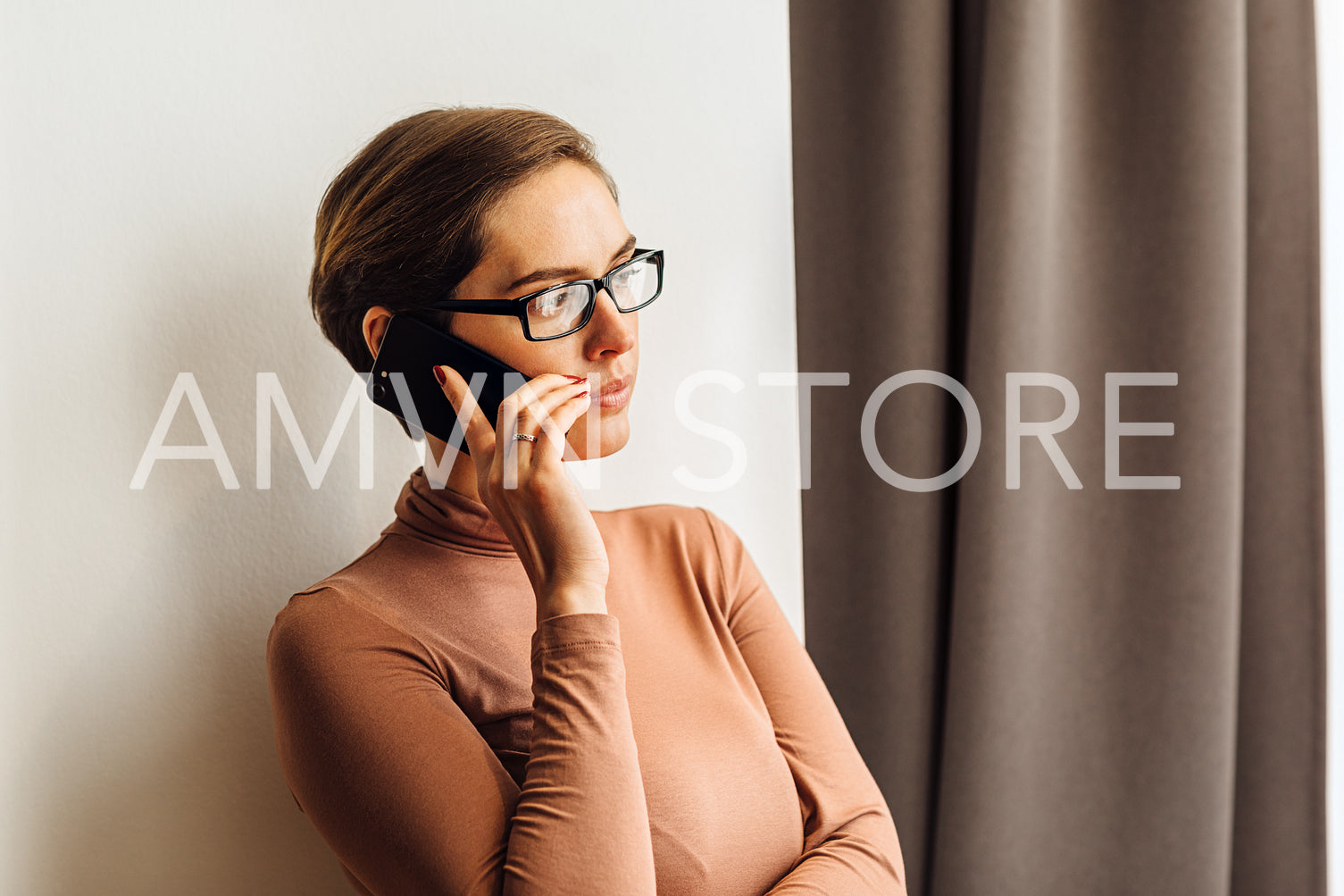 Businesswoman in casual clothes standing in a rental apartment and making phone call	