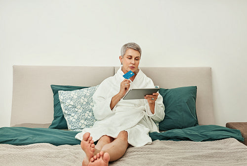 Mature woman relaxing on a bed