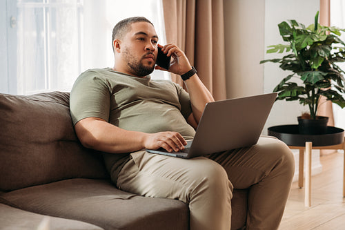 Young man at home working on his laptop