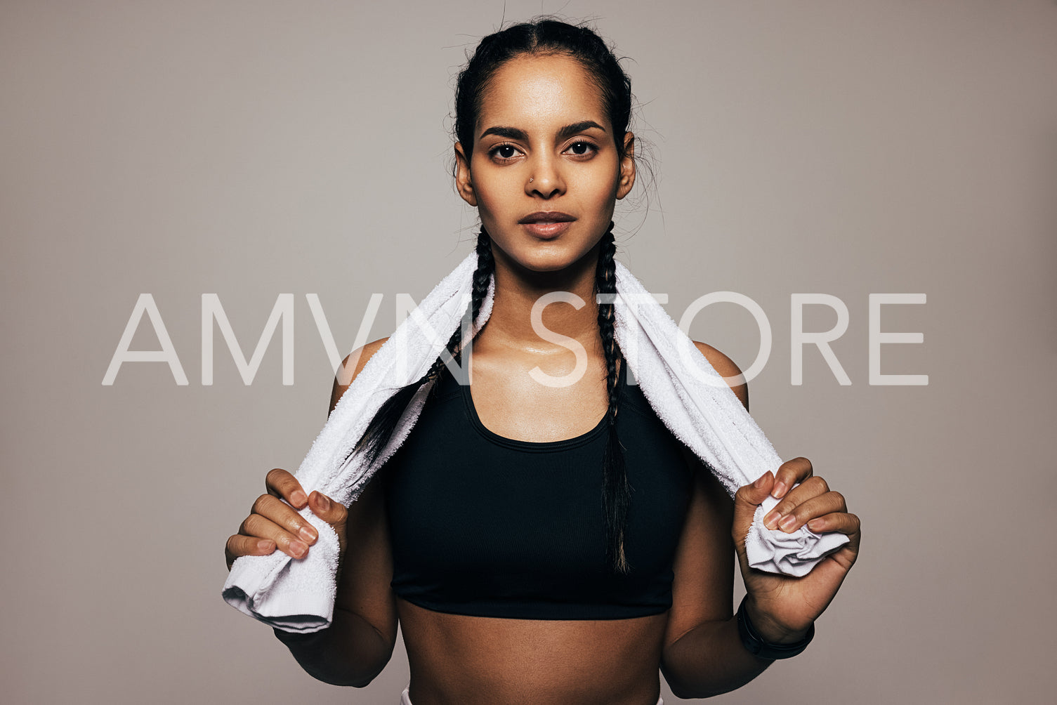 Close up portrait of a mixed race woman in sportswear holding a white towel