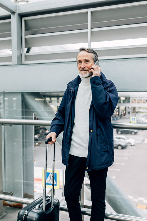 Senior man using mobile phone in the city