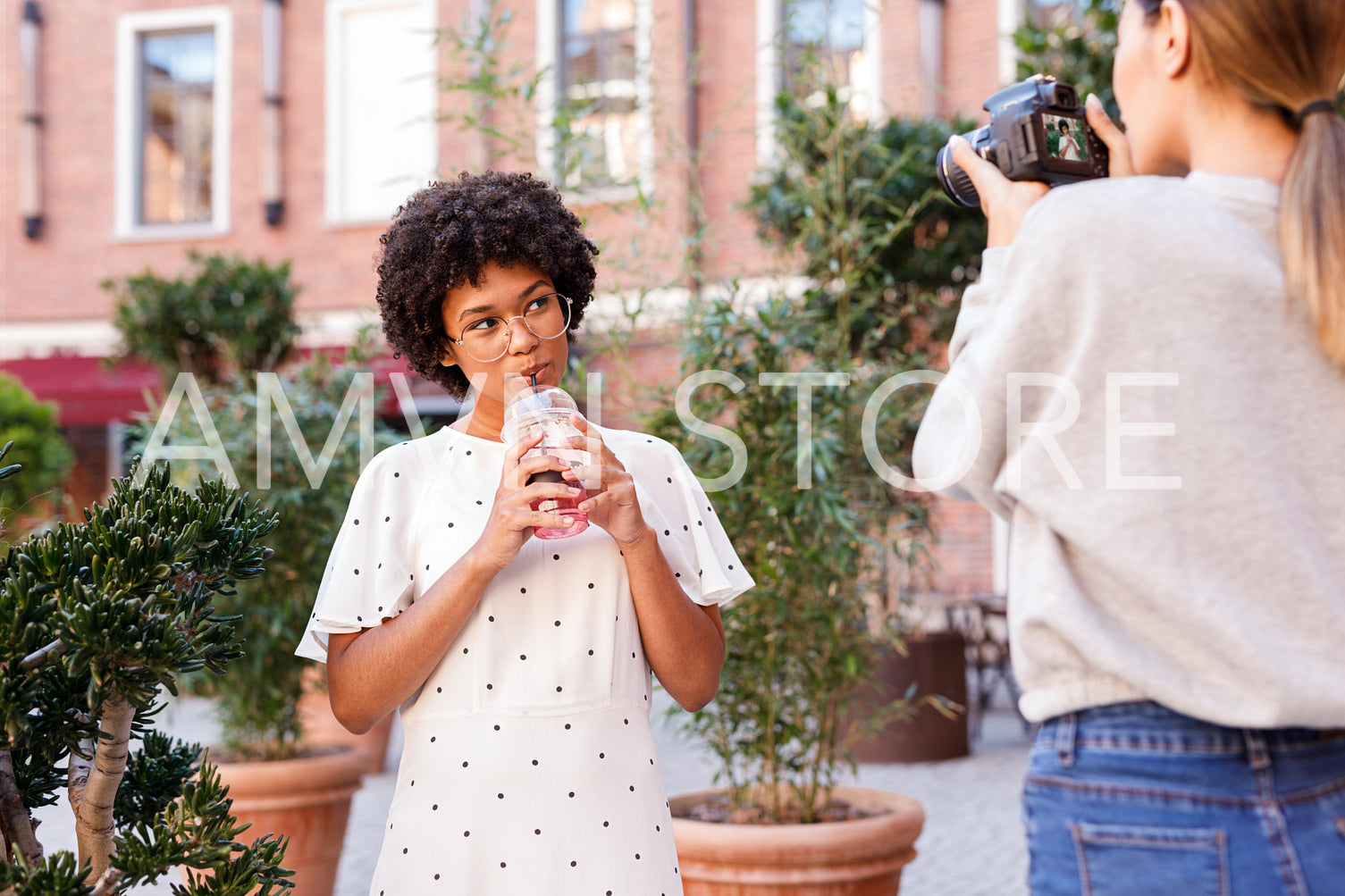 Photographer collaborating with a blogger. Two women creating content for social media.	