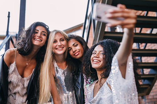 Happy friends taking a selfie. Women making a photo on cell phone.