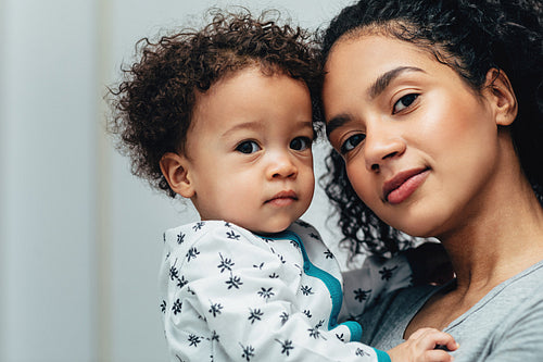 Portrait of a young mother and her son looking at camera