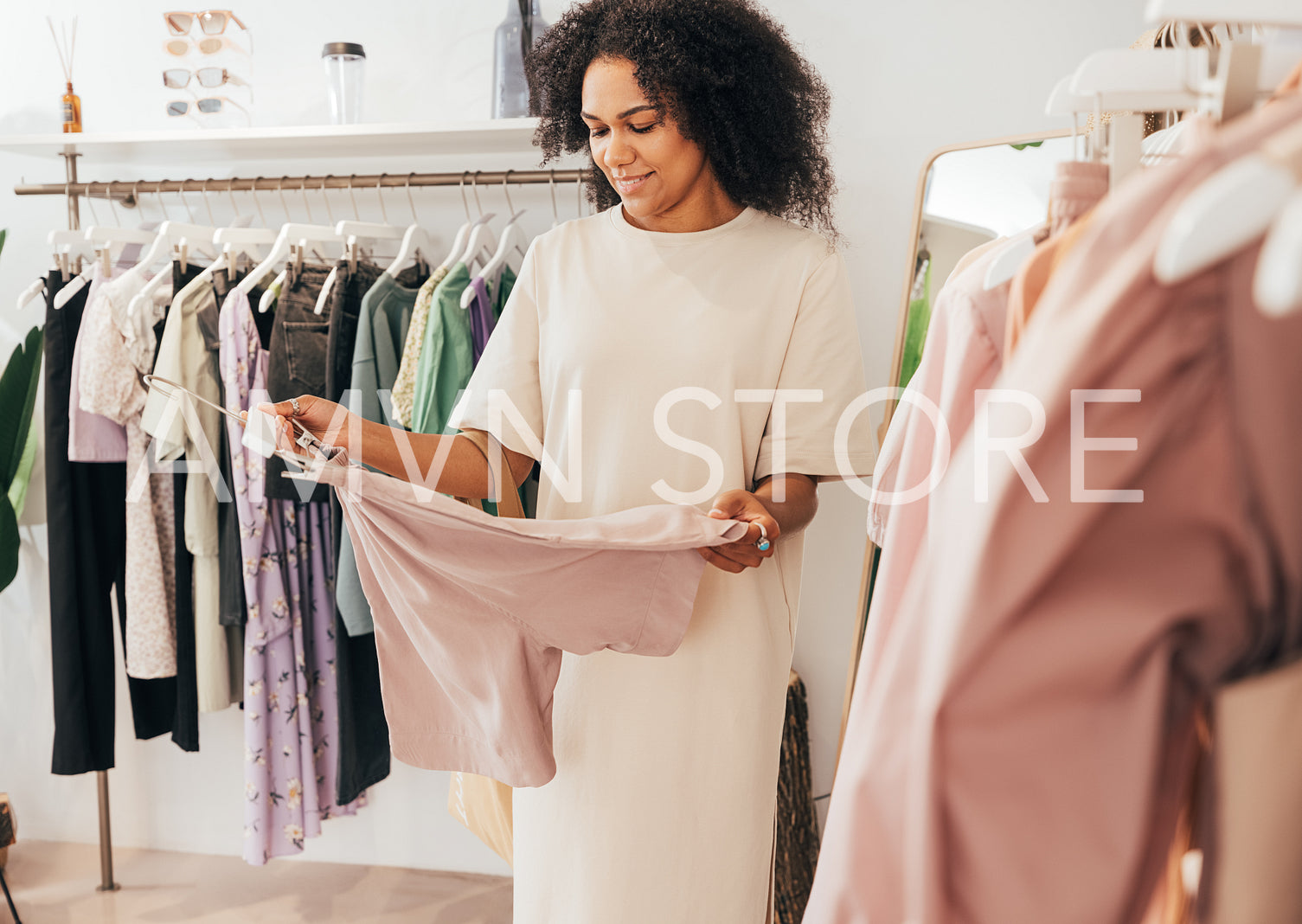 Young female buying clothes in local boutique