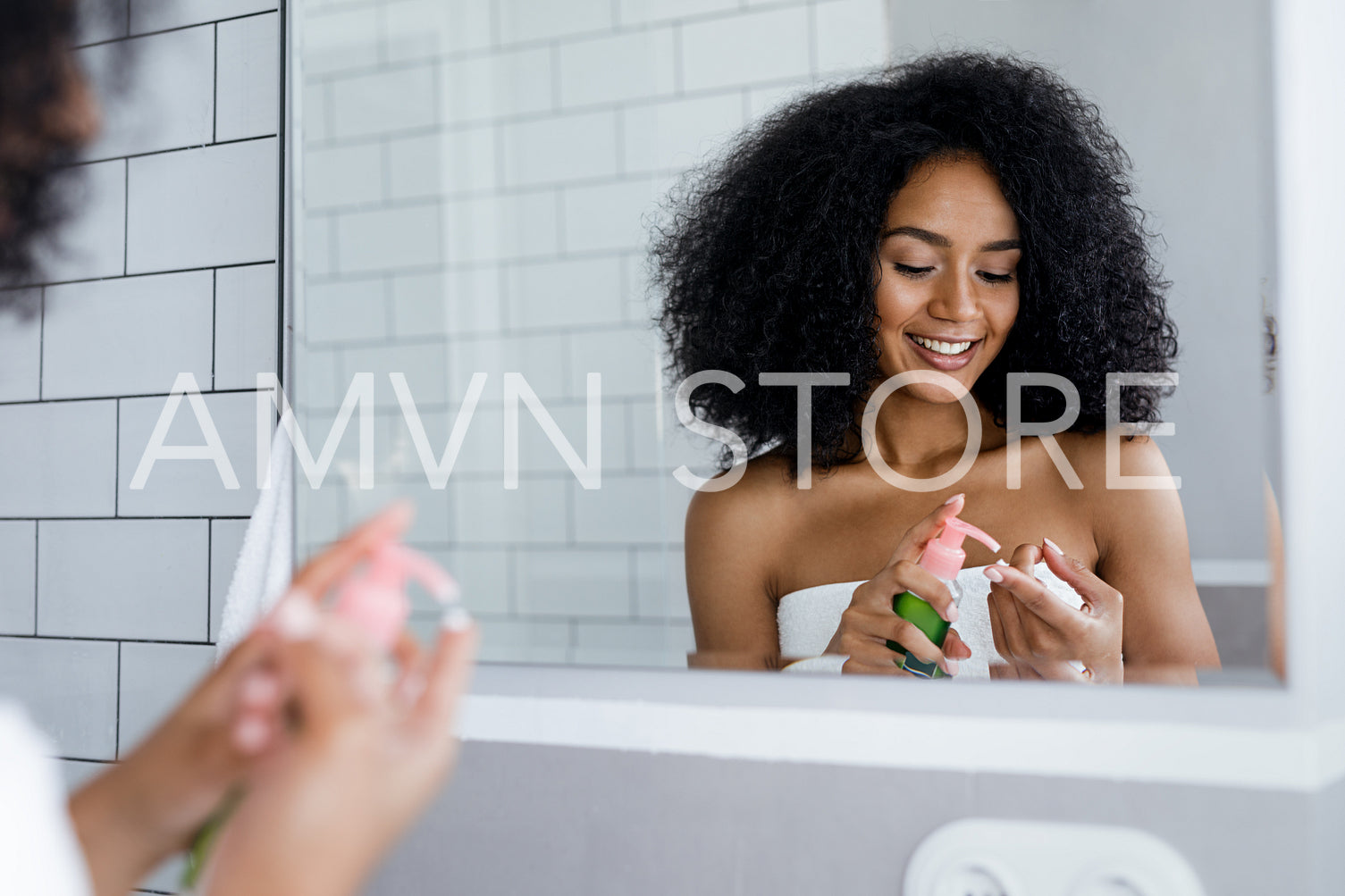 Smiling woman prepare for applying cosmetic cream on face in bathroom, standing in front of a mirror	