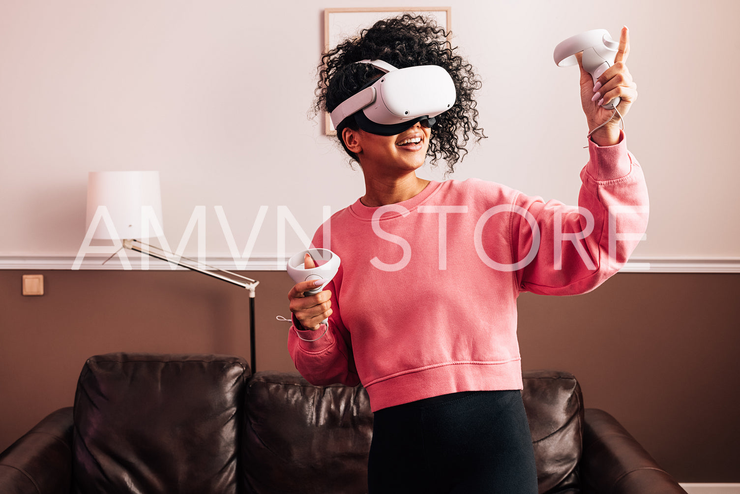 Young woman having fun with VR set. Smiling female using a virtual reality headset.