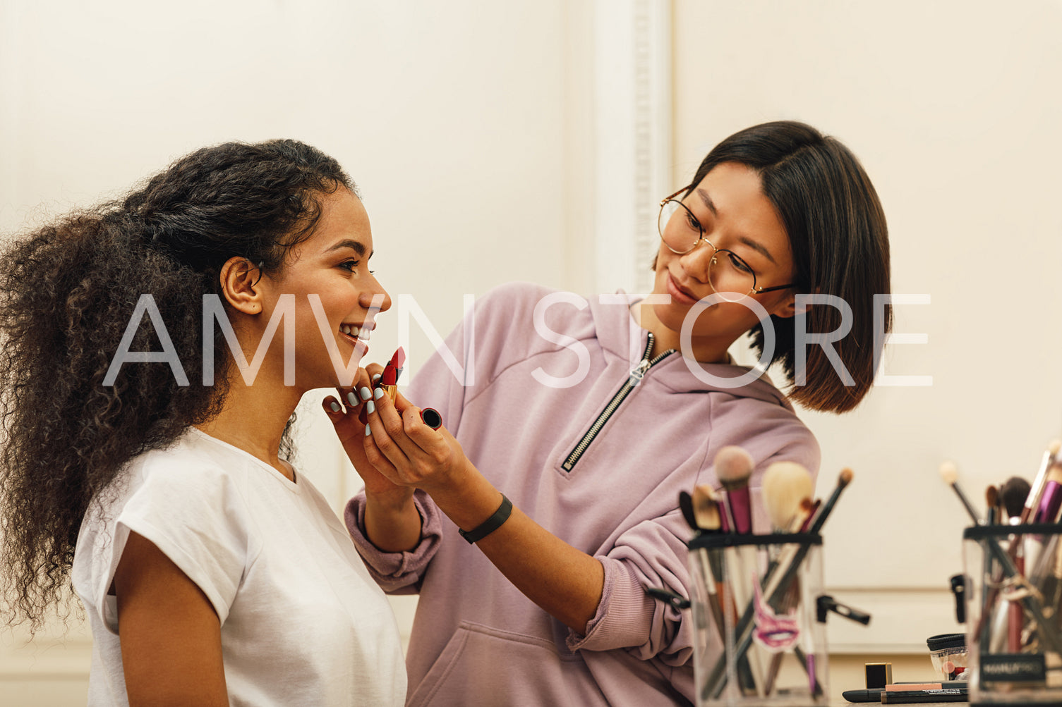 Makeup artist chooses lipstick color for model	