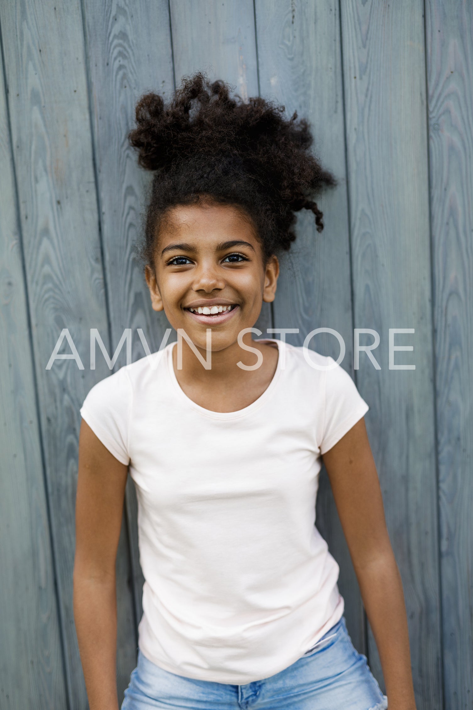 Portrait of little girl standing outdoors, wearing casual clothes	