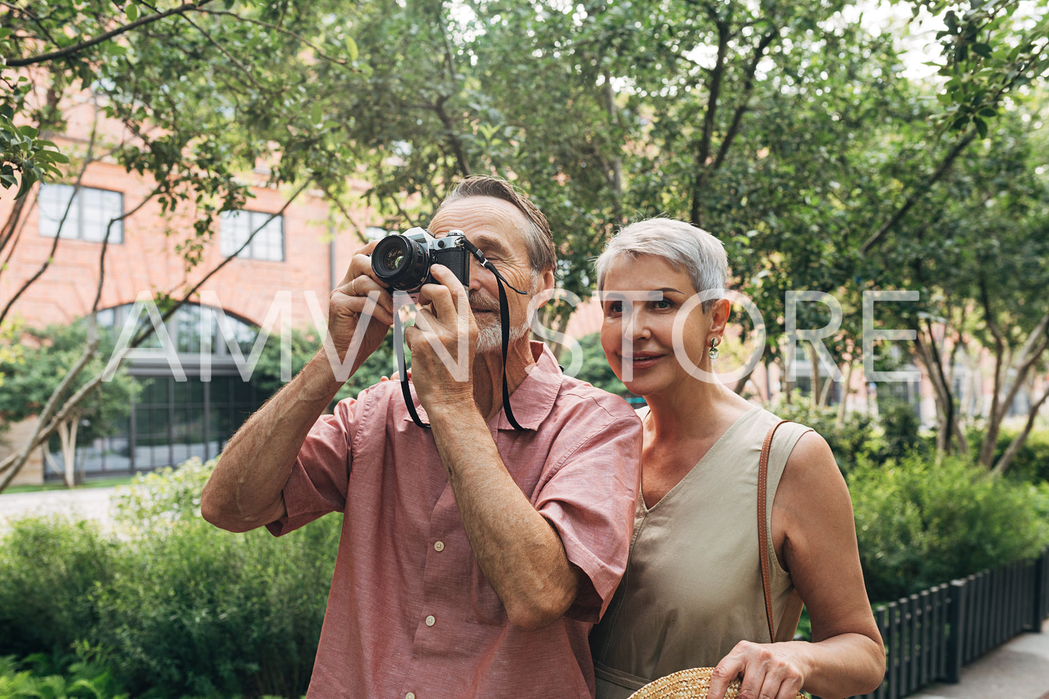 Senior couple stopped during a walk to take a picture of something