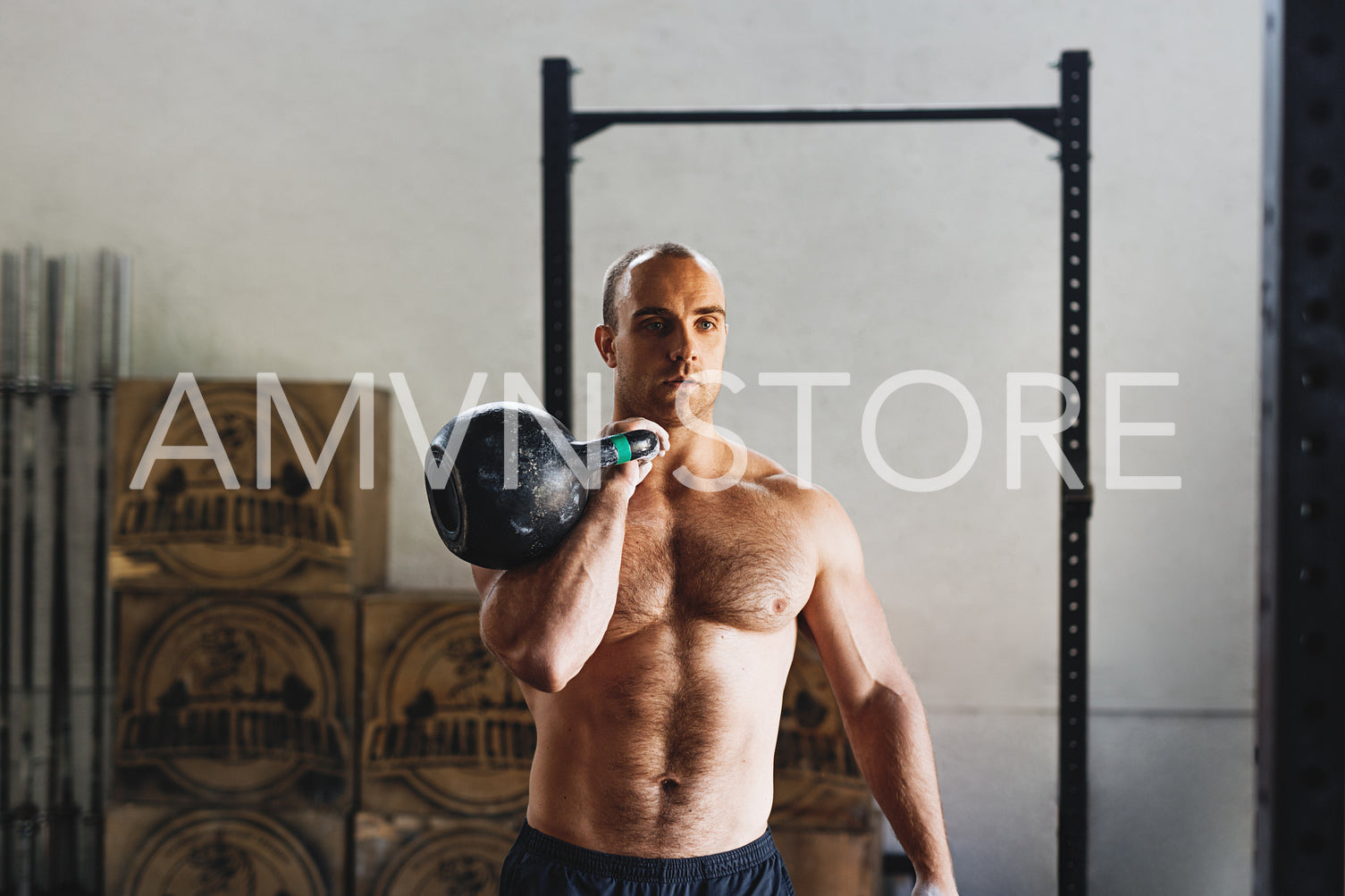 Fitness man doing exercises with kettlebell in gym	