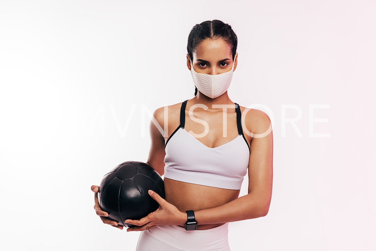 Fitness woman wearing face mask exercising with a medicine ball	