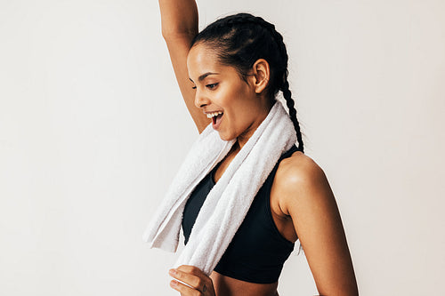 Side view of a happy mixed-race woman with a white towel around her neck