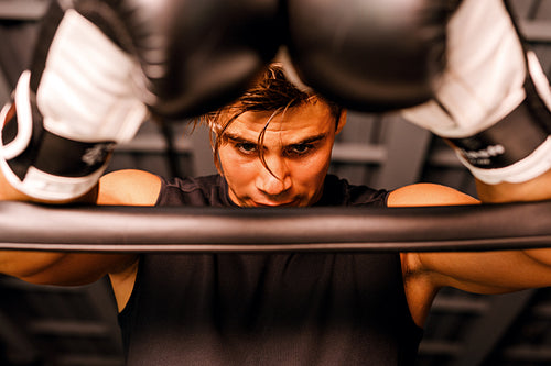 Tired boxer taking a break after a practice in gym