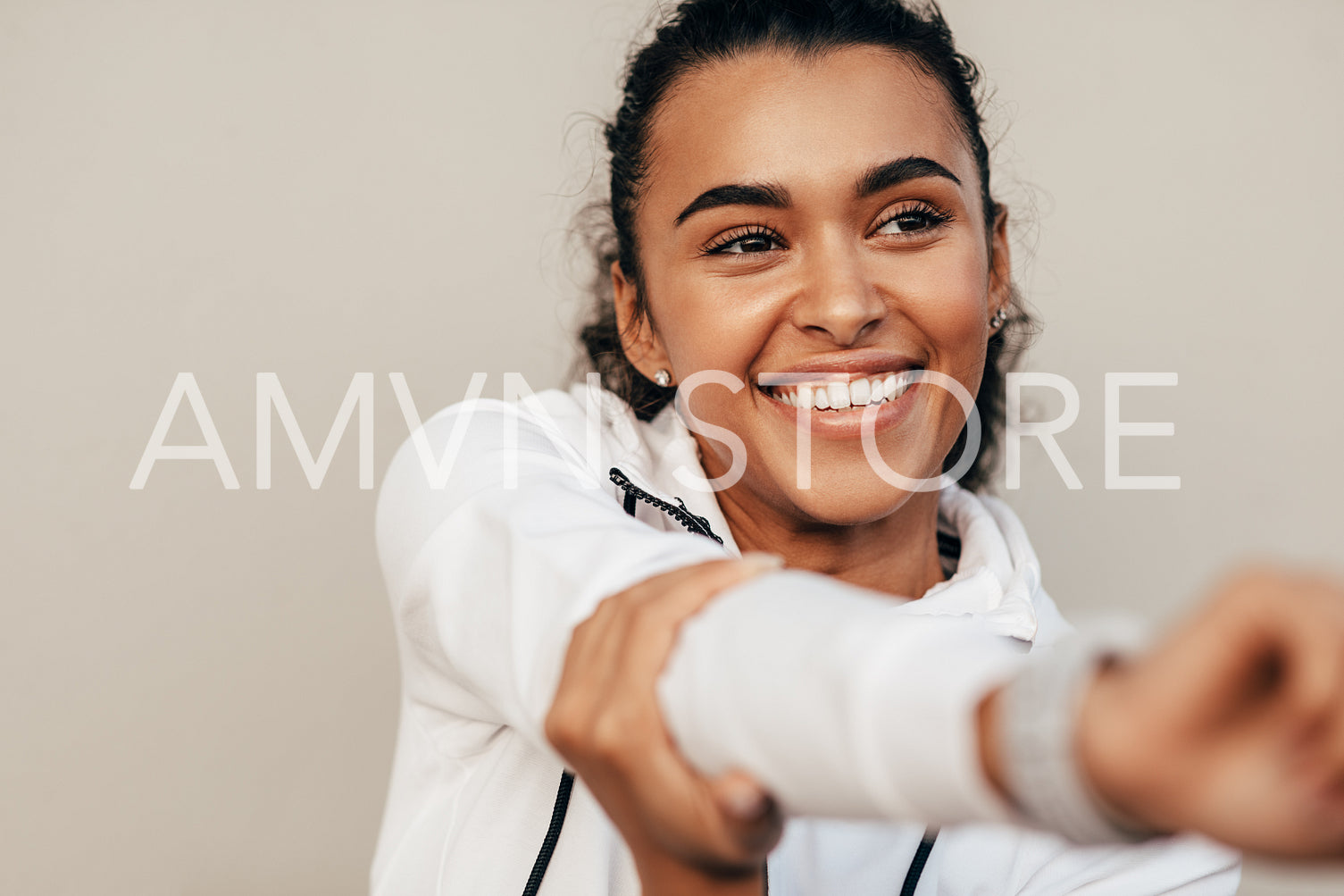 Close up of smiling sports woman warming up her hand before training	