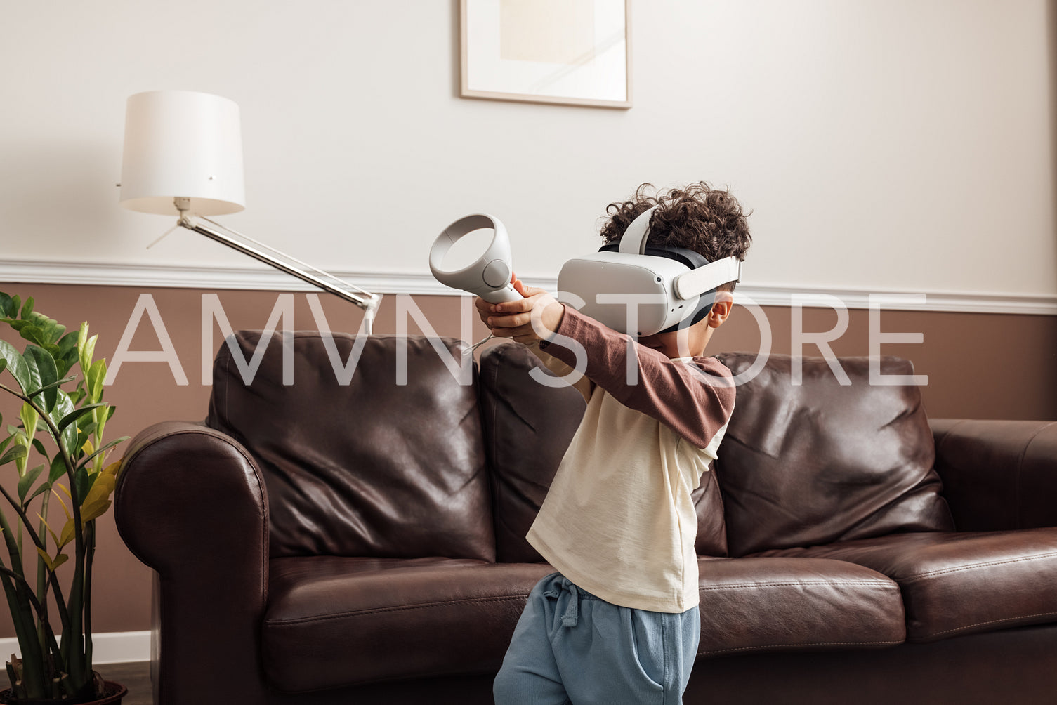 Kid playing virtual reality game in a living room holding joysti