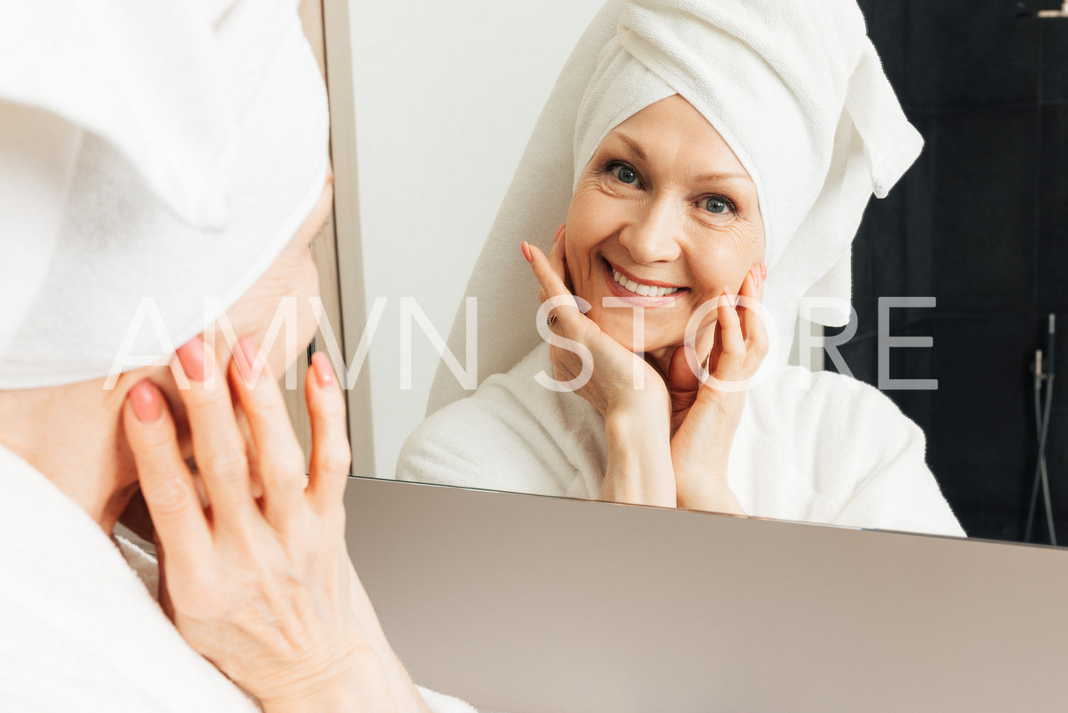 Cheerful senior woman with towel on head looking at camera