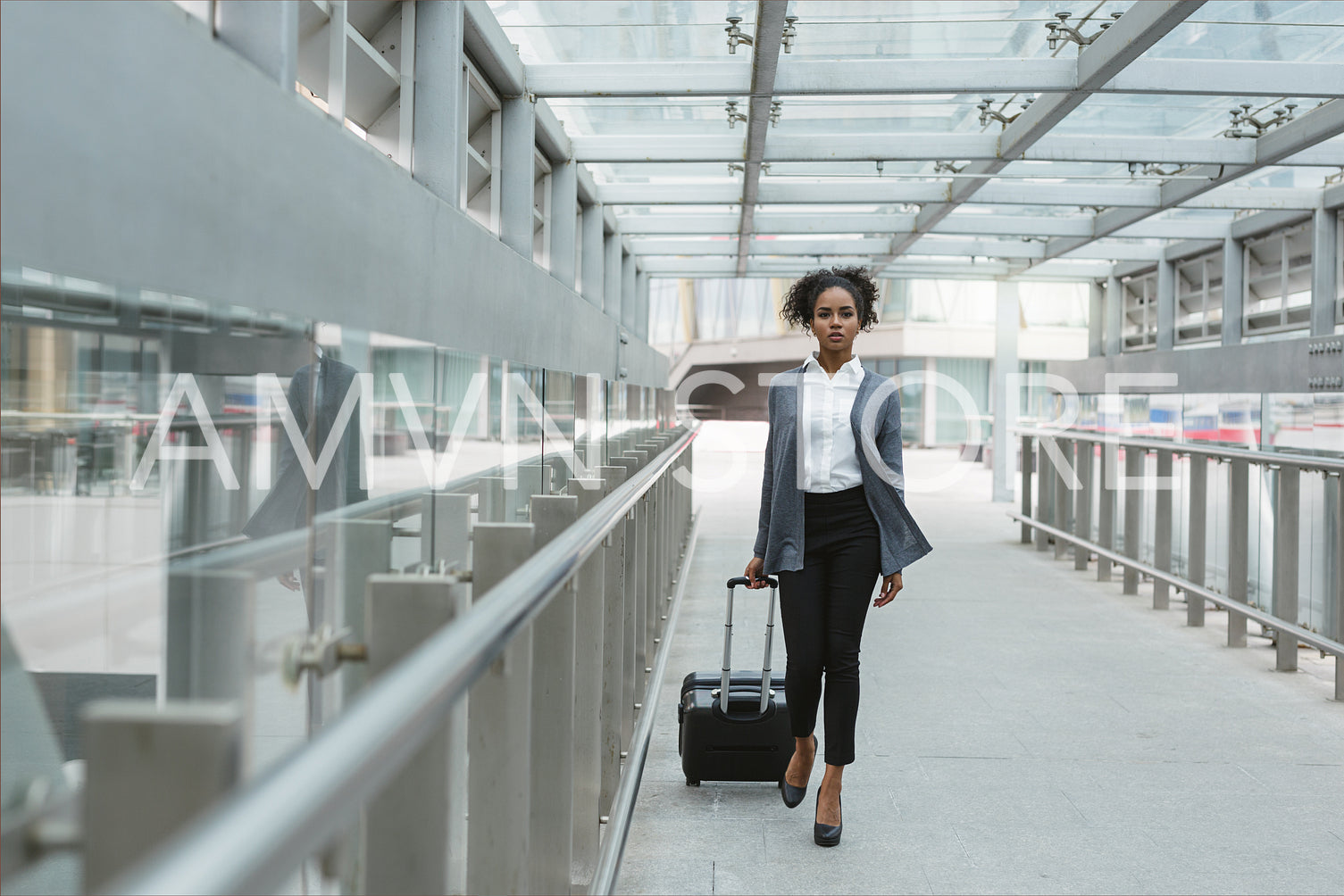 Beautiful woman with suitcase walking in airport corridor	