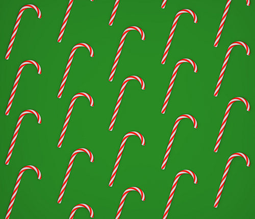 A lot of candy canes on a green background