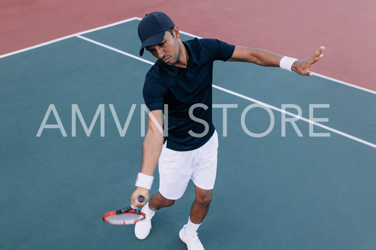 High angle of a professional tennis player practicing on a hard court