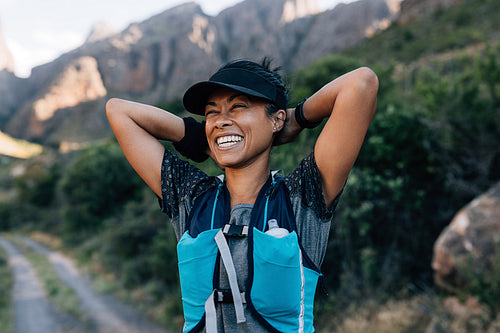 Laughing woman hiker taking a break during her hike