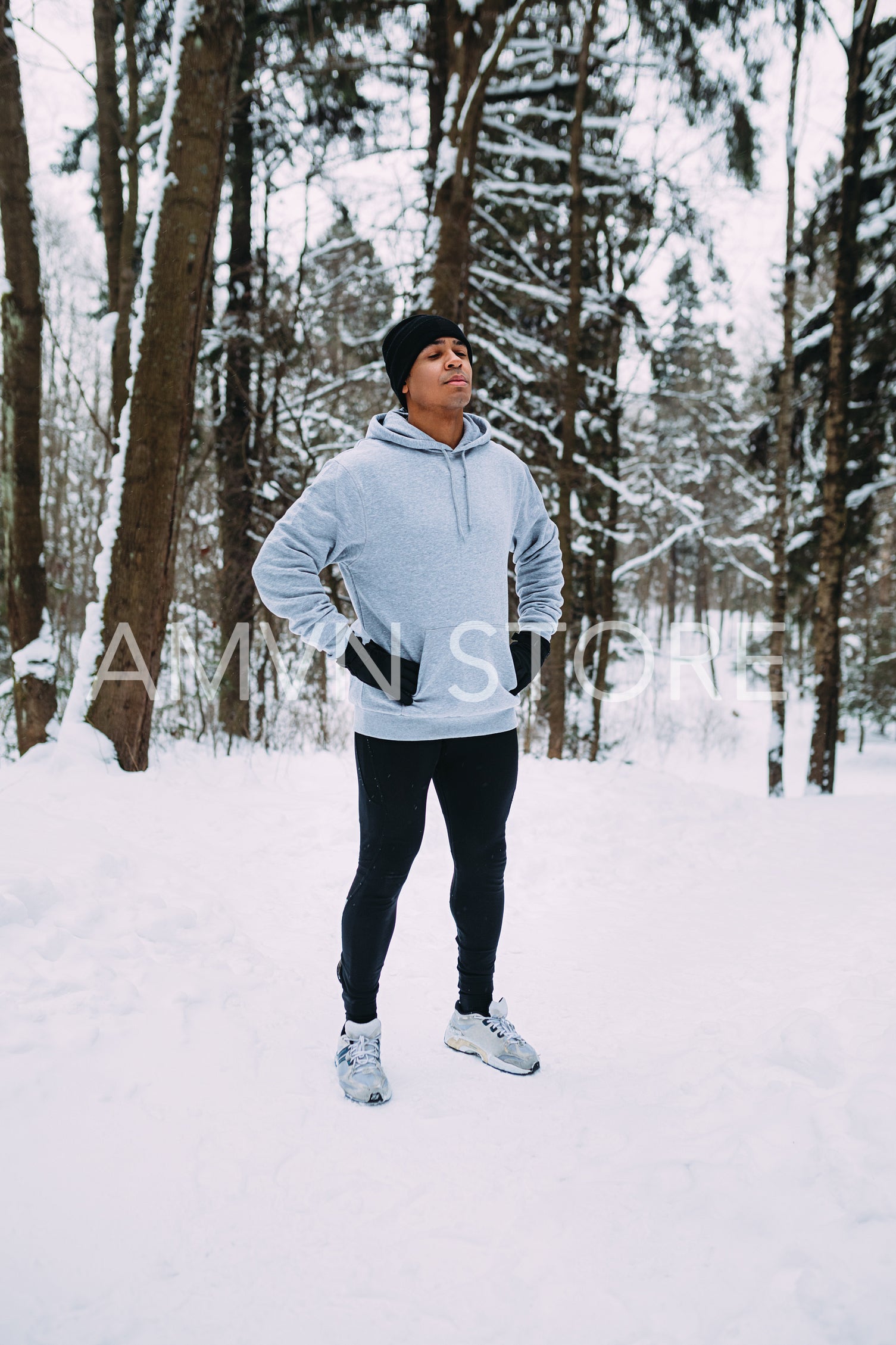 Athlete standing in a forest. Man resting after exercises.	
