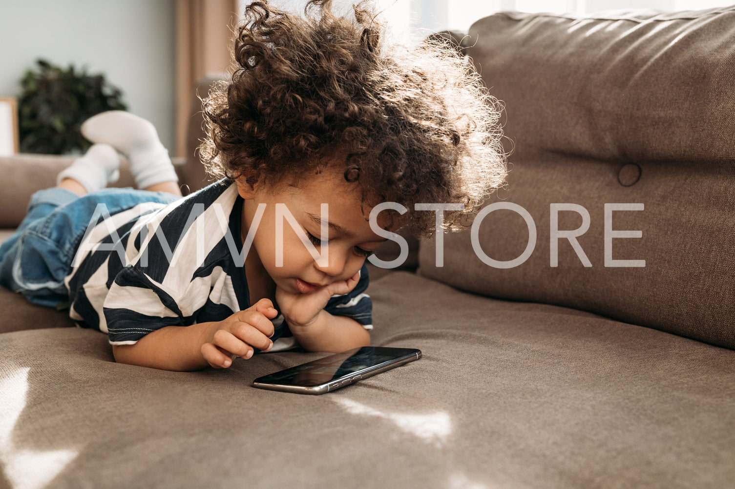 Toddler watching video on a smartphone at home