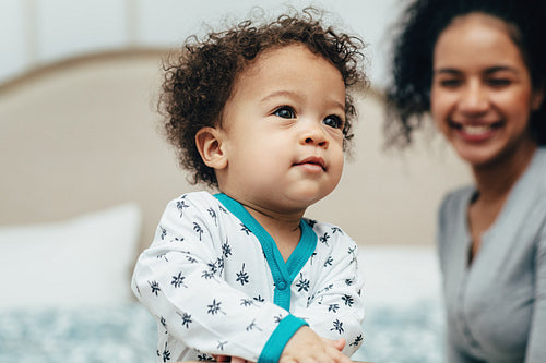 Portrait of a baby boy and his mother on the background