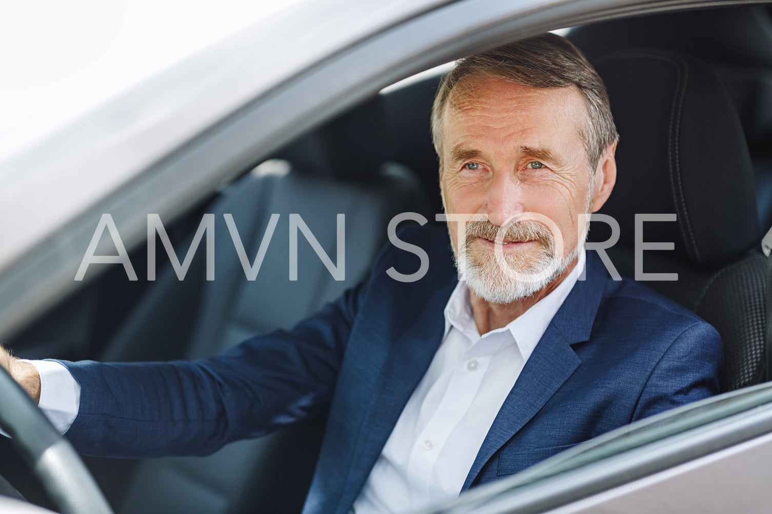 Senior driver sitting inside a car wearing formal wear	