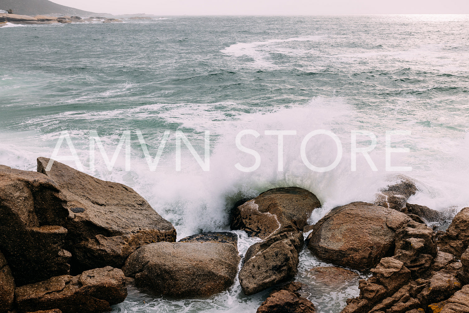 Ocean coast with rocks and big waves at sunset