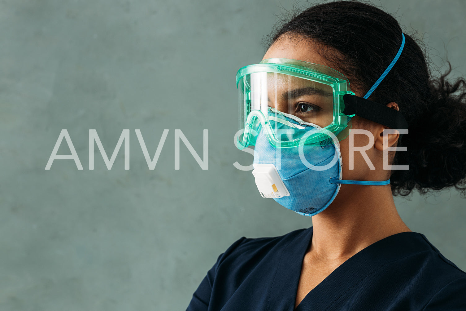 Side view of medical worker wearing suit, respirator and glasses