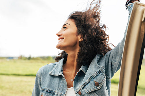 Side view of brunette woman with her hair flying in the air