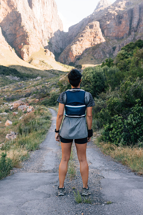 Young healthy hiker standing on abandoned road