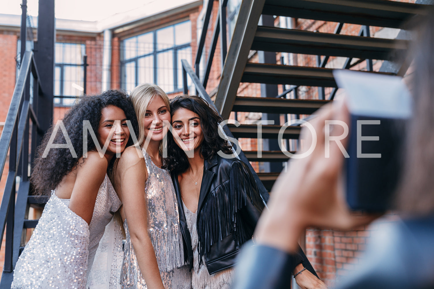 Woman taking photos of her friends outdoors with an instant camera	