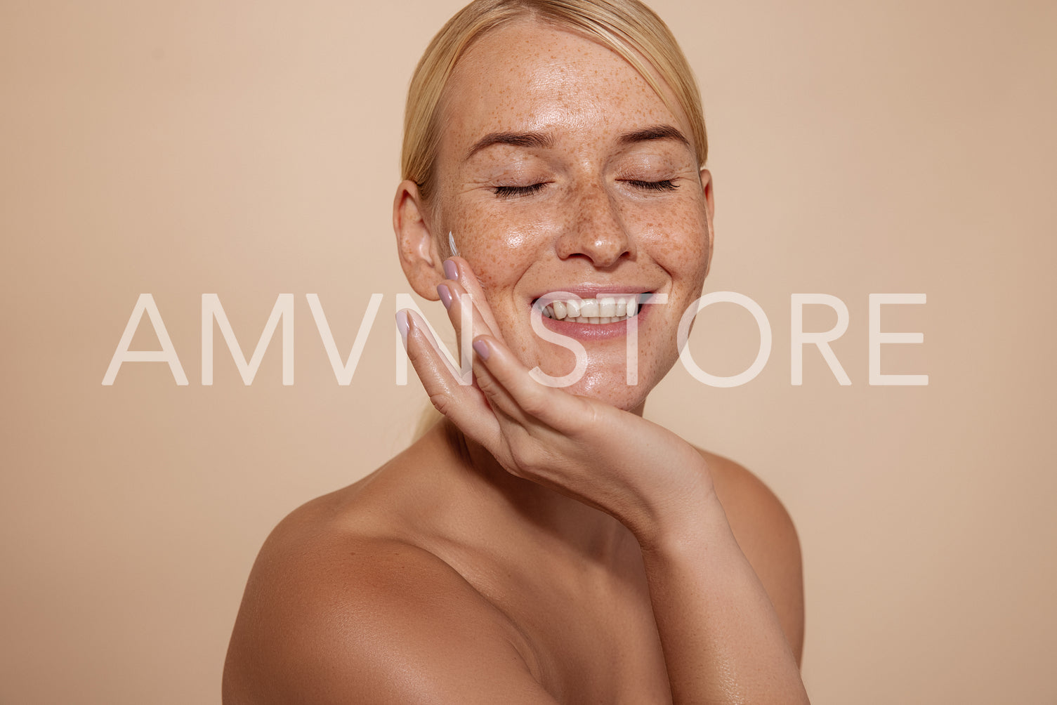 Happy woman with natural beauty skin. Smiling female touching face against pastel background in studio.