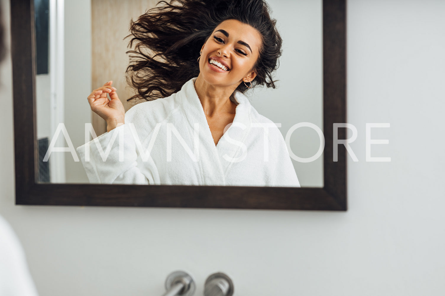 Happy woman enjoying good mood after home spa looking at mirror	