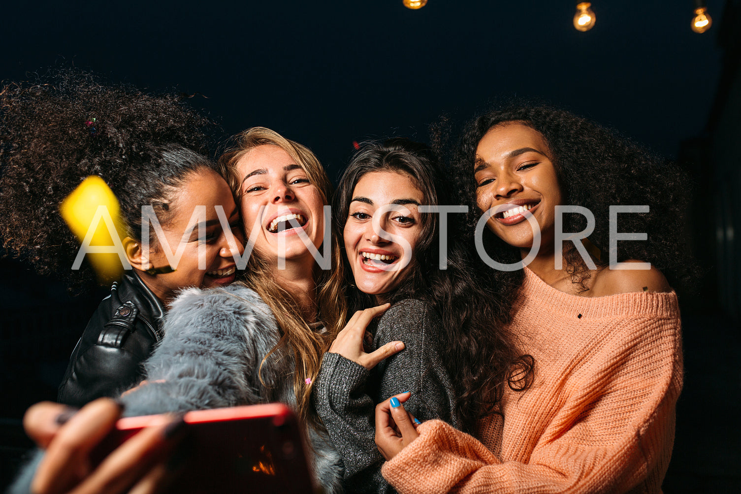 Four happy female friends taking selfie and embracing