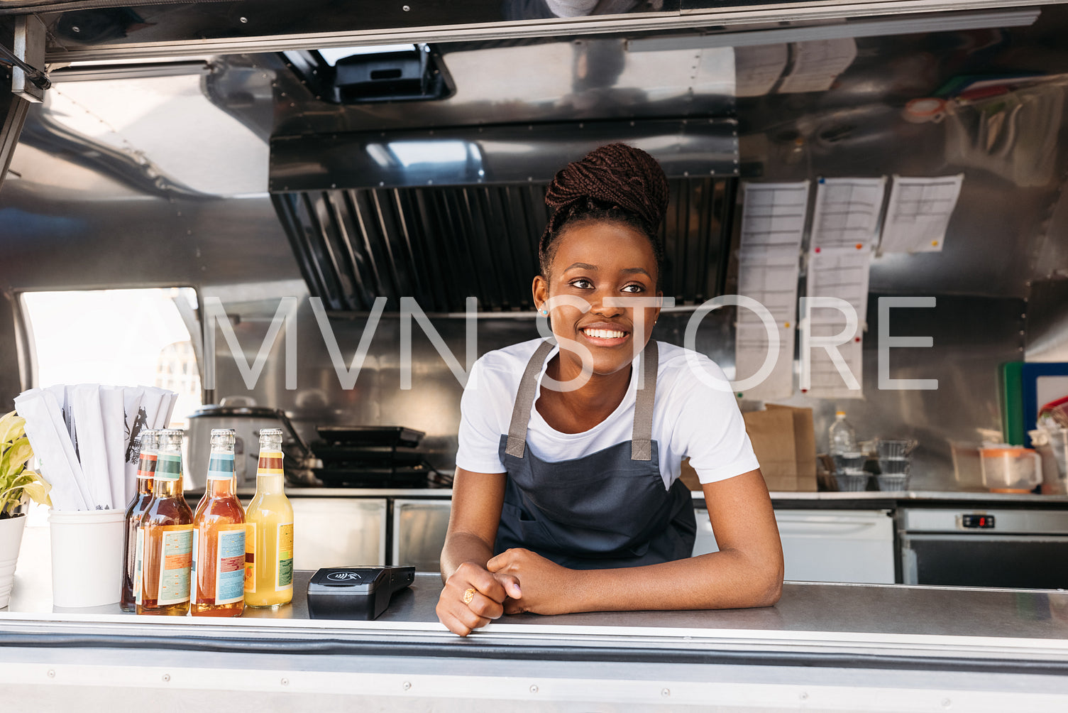 Portrait of young small business owner standing in her food truck waiting for clients