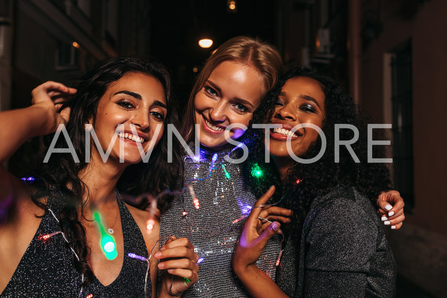 Three friends celebrating new year on night street