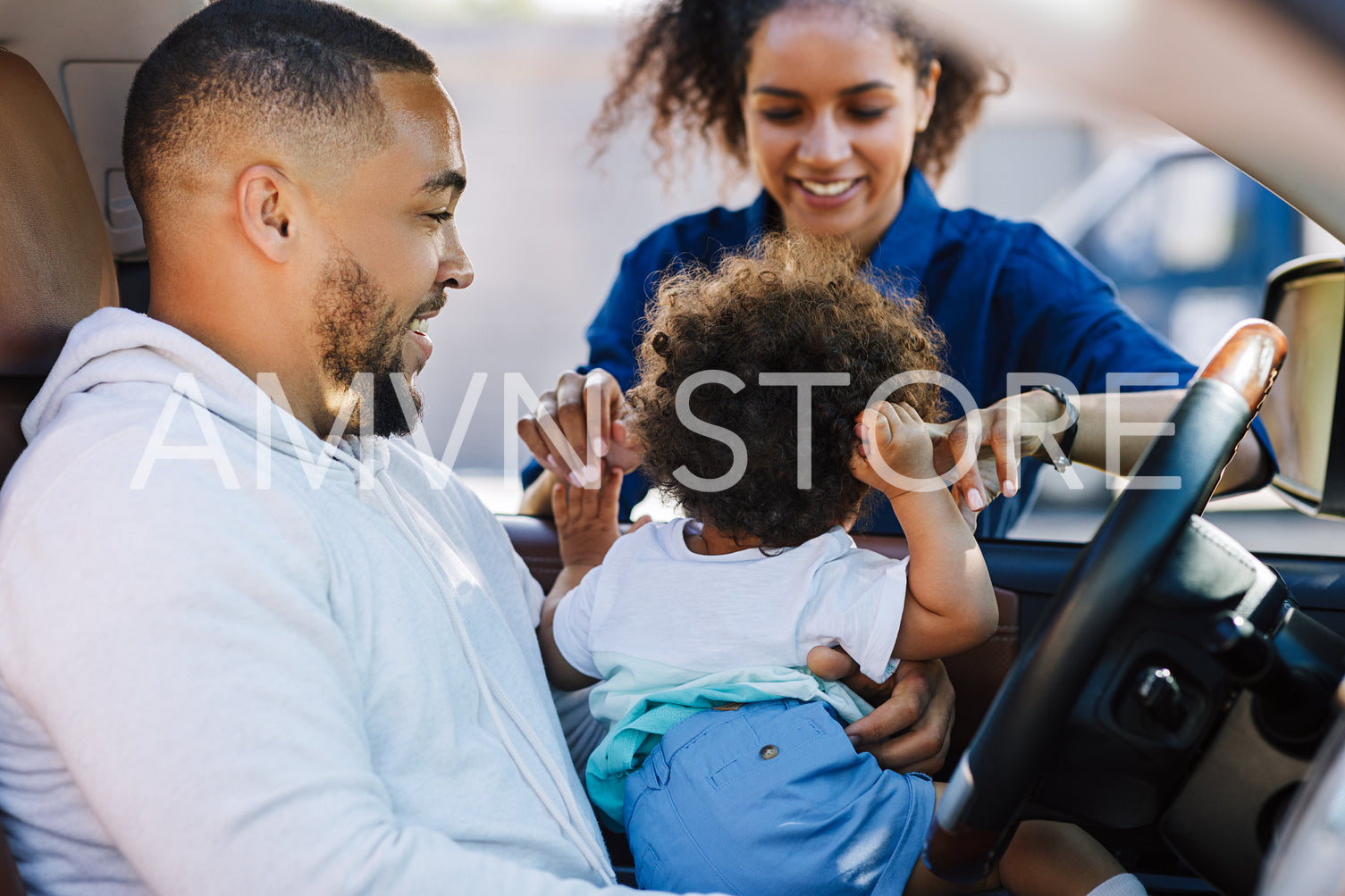 Young mother playing with his son. Little boy sitting on father's hips.	