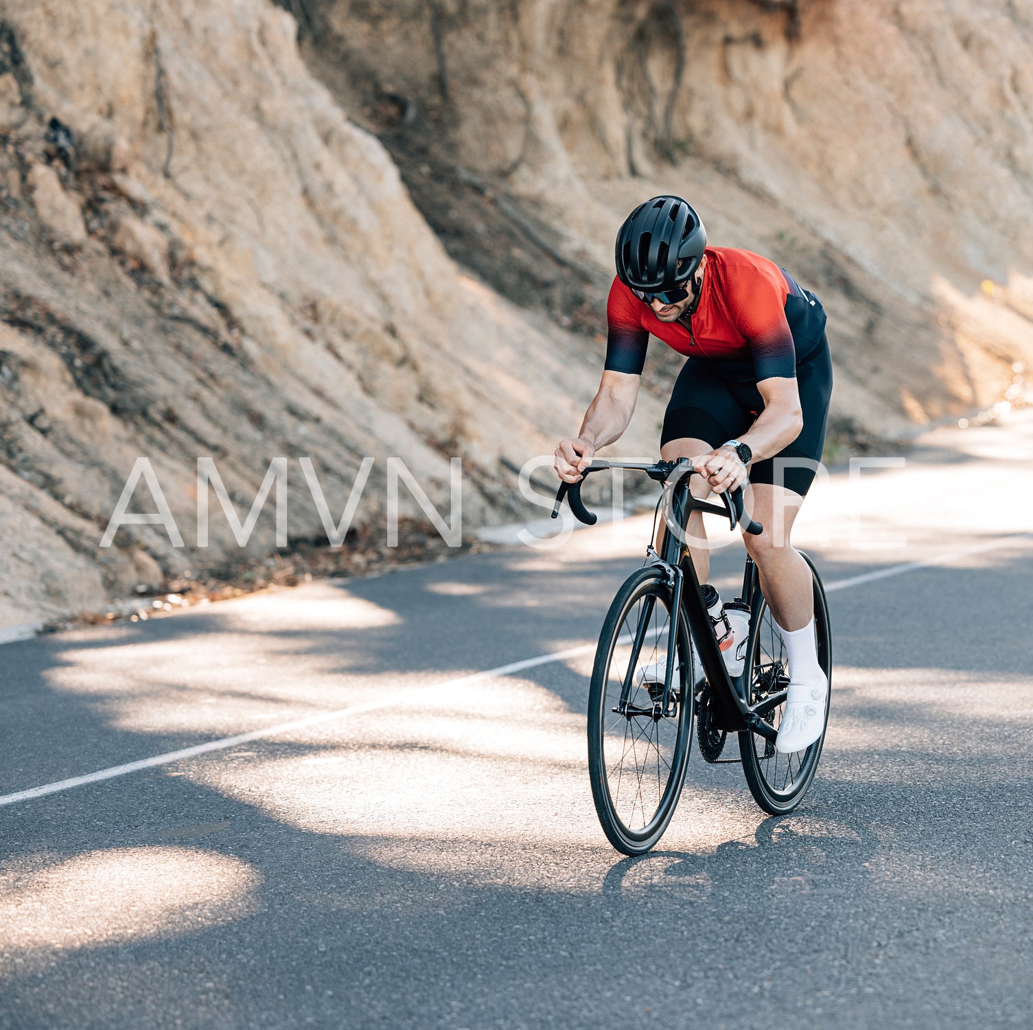 Professional cyclist in helmet and glasses riding a road bike