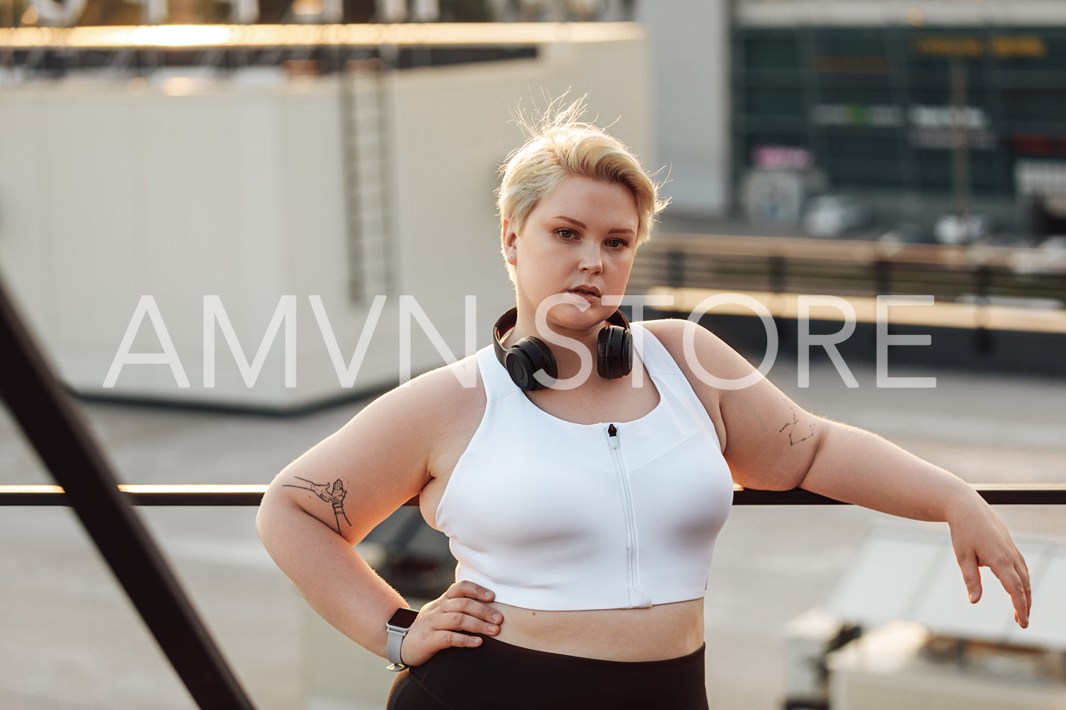 Portrait of a confident plus-size woman standing on a roof