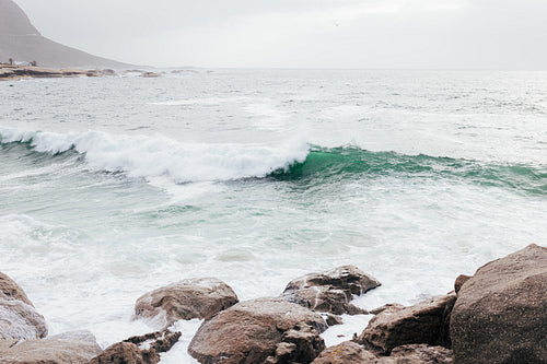 Waves on ocean at sunset near a coast