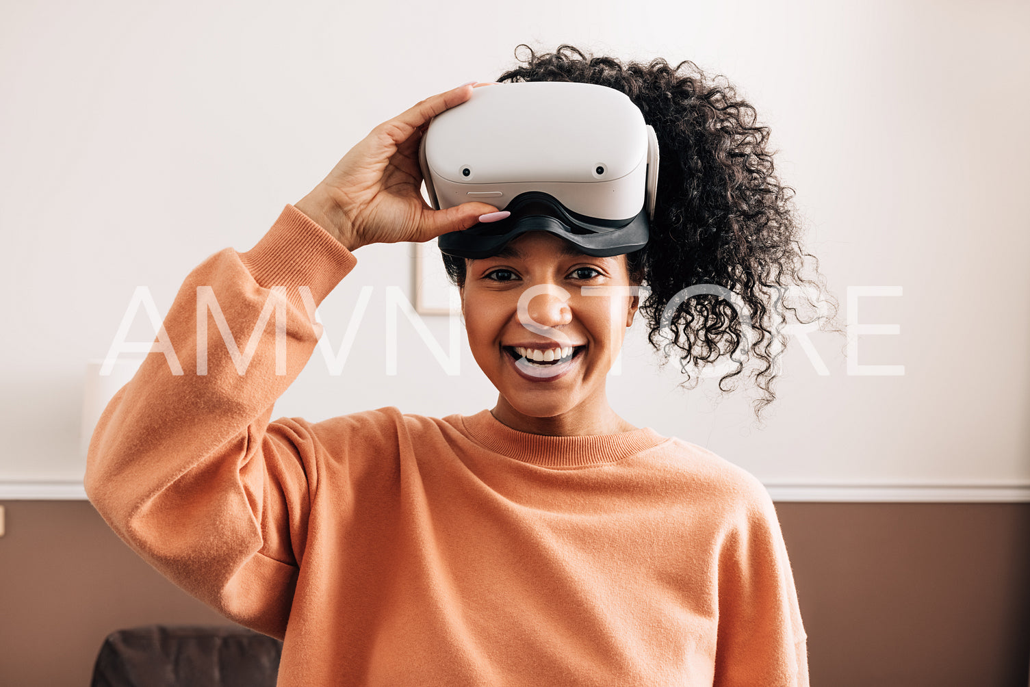 Portrait of mixed race woman holding a VR glasses looking at camera