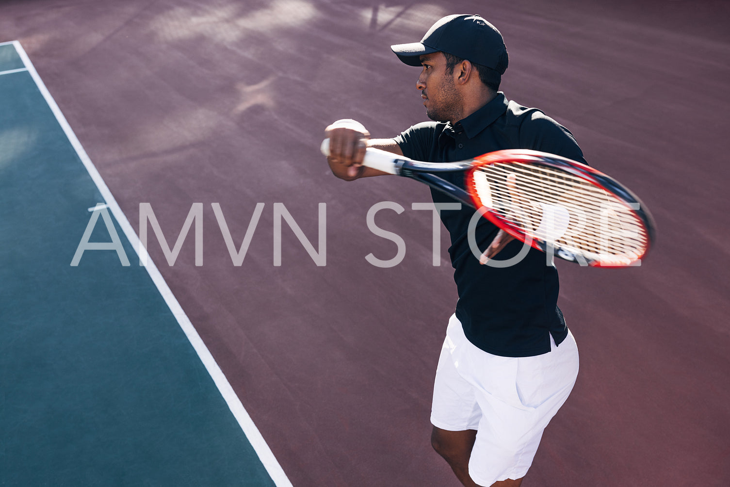 Tennis player on hard court exercising at sunset